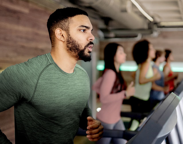 A man running on a treadmill in a stylish gym