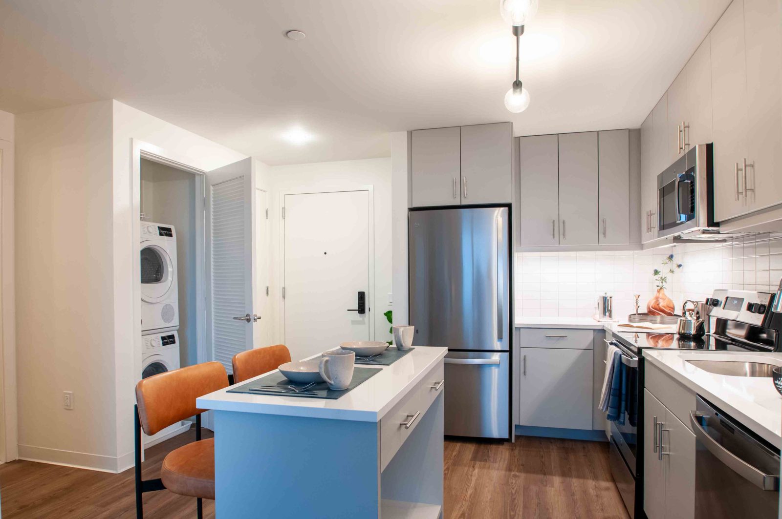 Kitchen with island and in-unit washer dryer